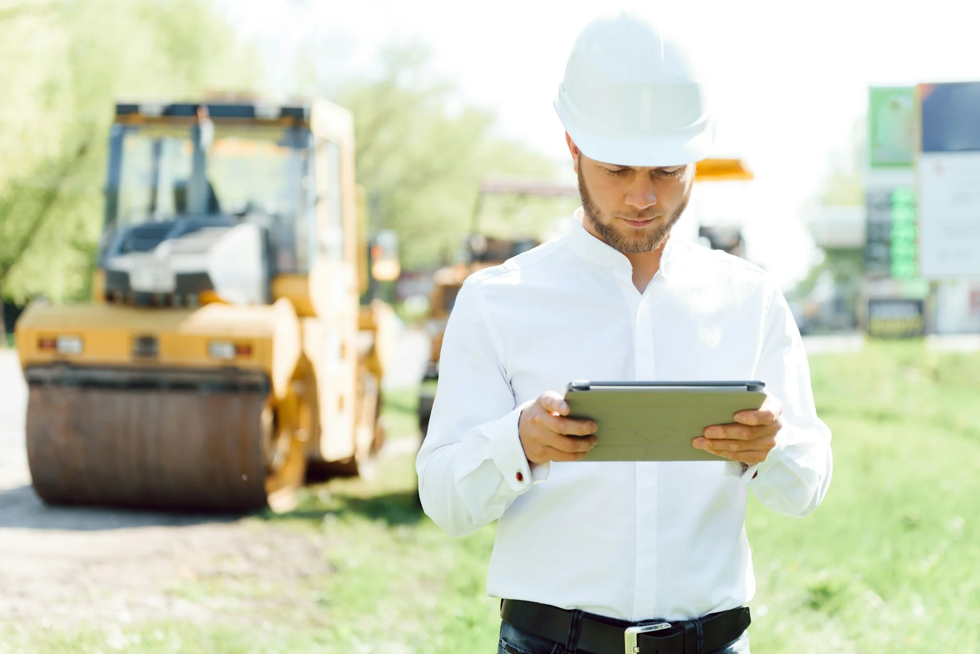 engineer near road machinery. The concept of building a new asphalt road. Road repair.